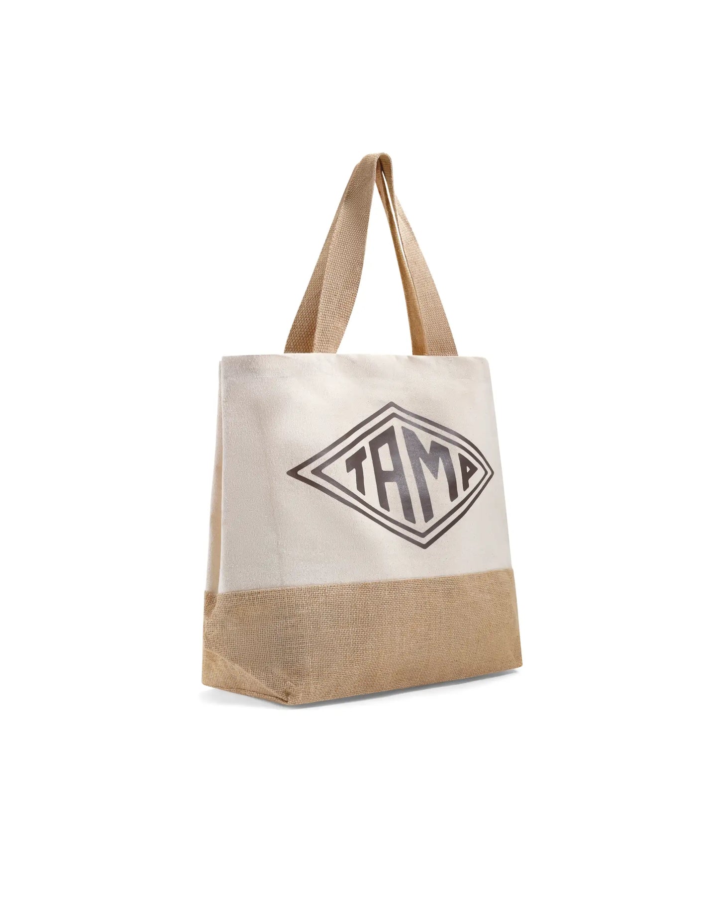 Diagonal view of heavy duty canvas and jute shopper with brown arpillera base, white fabric, brown handles, and black Tamp Coffee logo in center