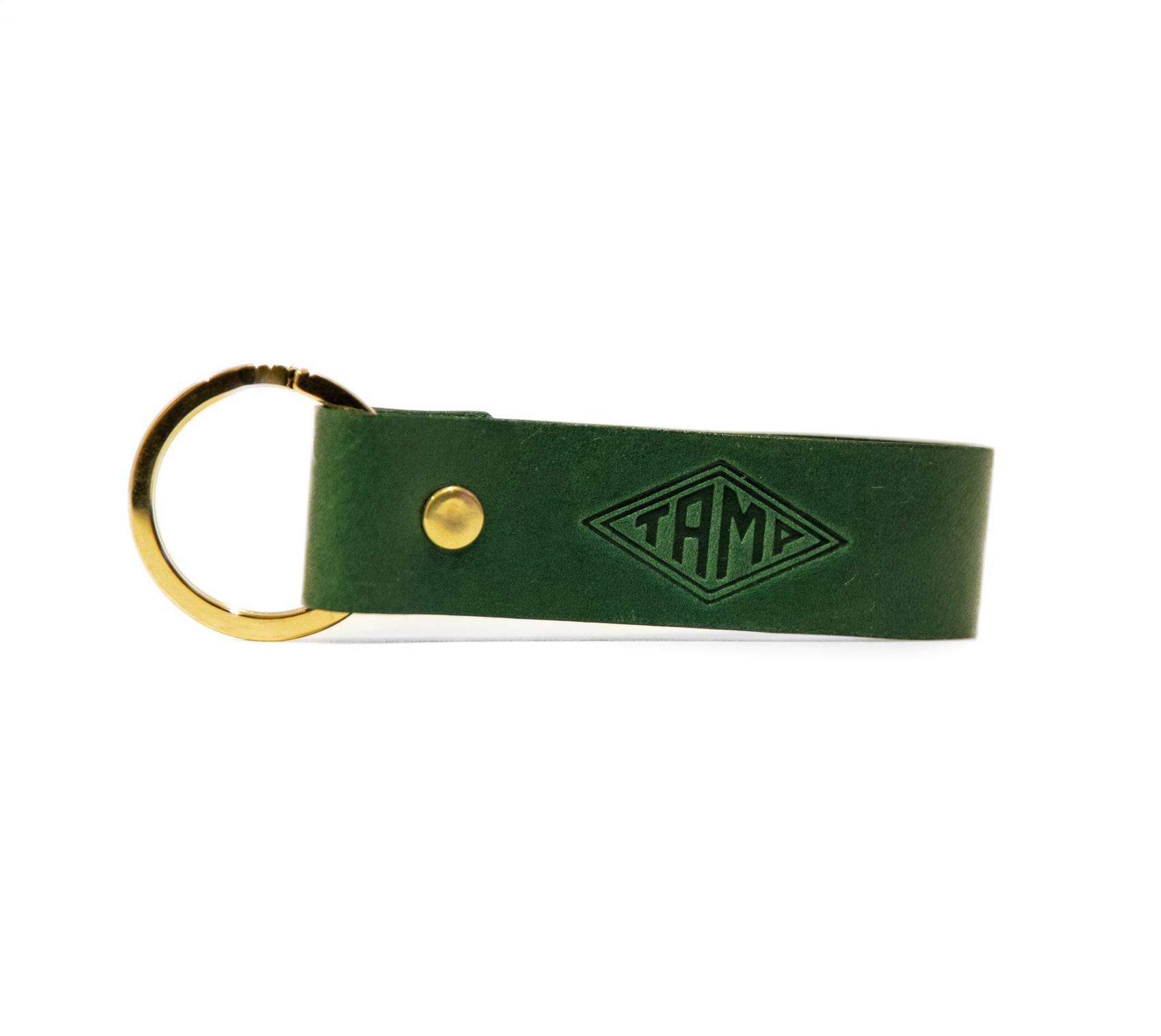 front view of a handcrafted green leather keyring from Tamp Coffee, featuring intricate stitching and embossed logo detail